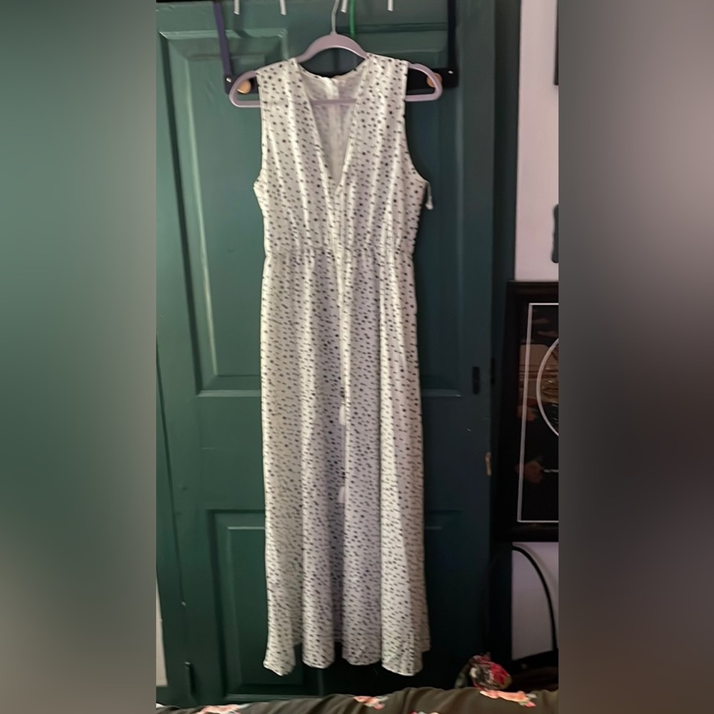 Long, sleeveless, flowy dress. White with black polka dots. Cinched at the waist